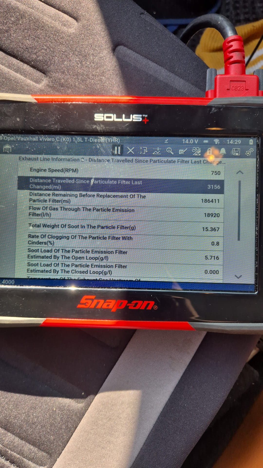 Mechanic using diagnostic equipment on a vehicle